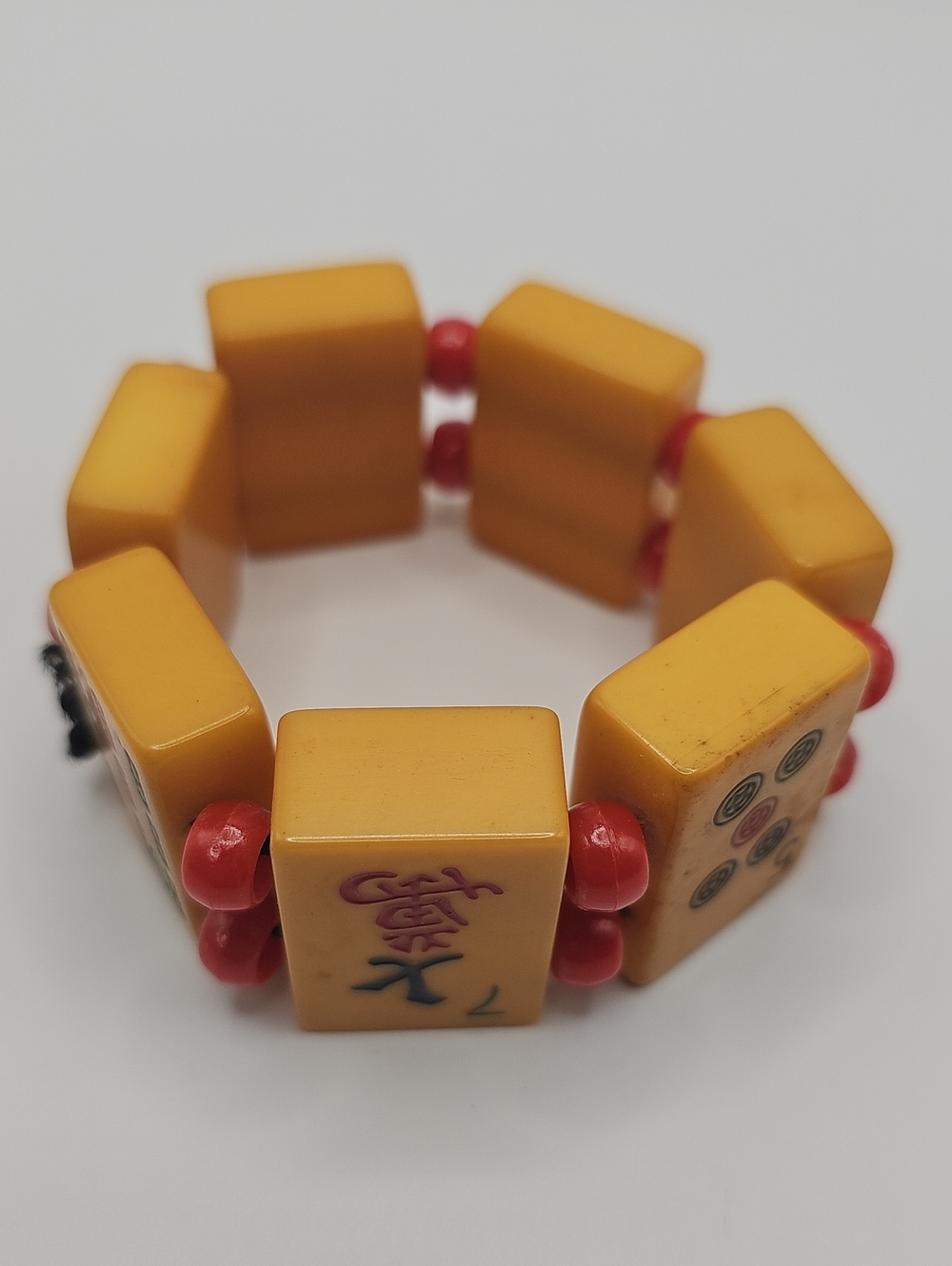 Butterscotch Bakelite Mahjong Tile Stretch Bracelet with Red Beads.